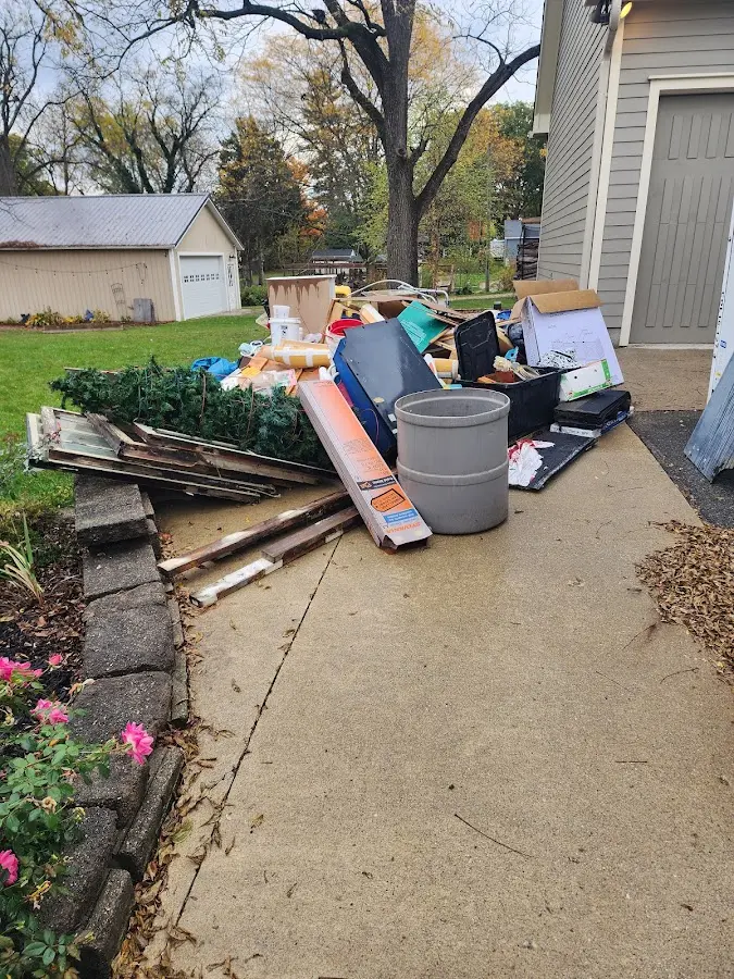 Dumpster being loaded with debris for 10 Yard Dumpster Rental in Putney